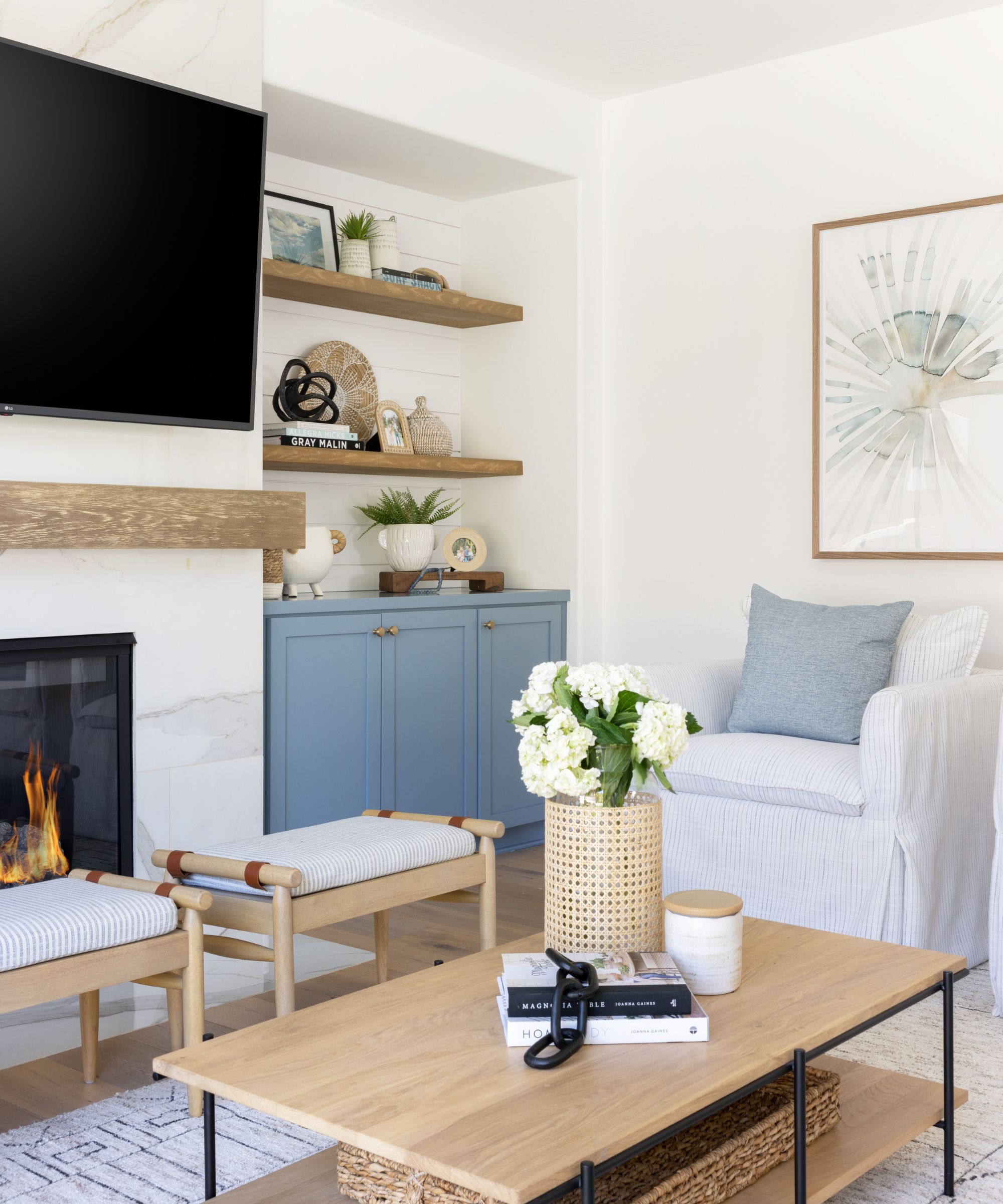 salon avec murs blancs, décor bleu et accents de bois