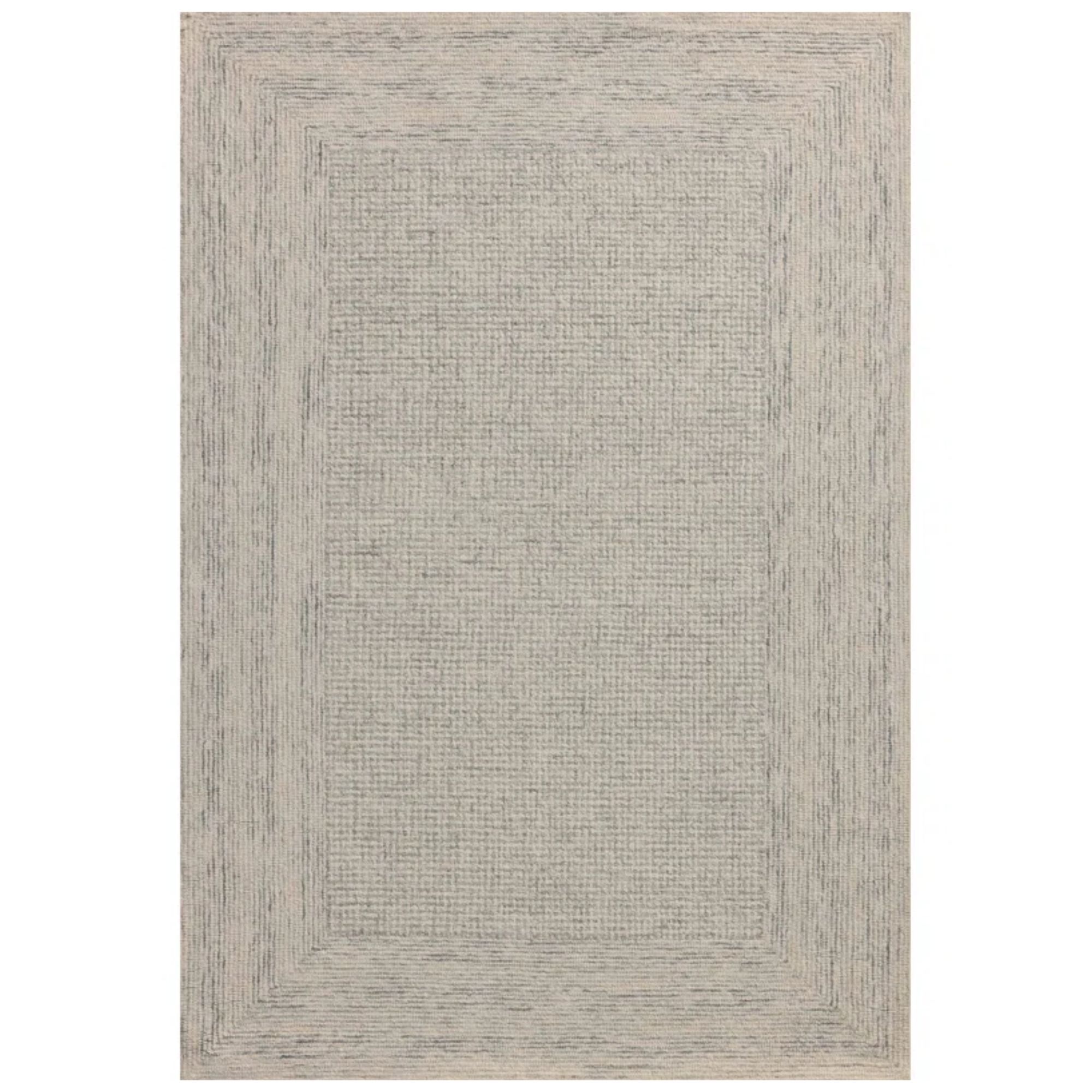 Un tapis beige et gris beige