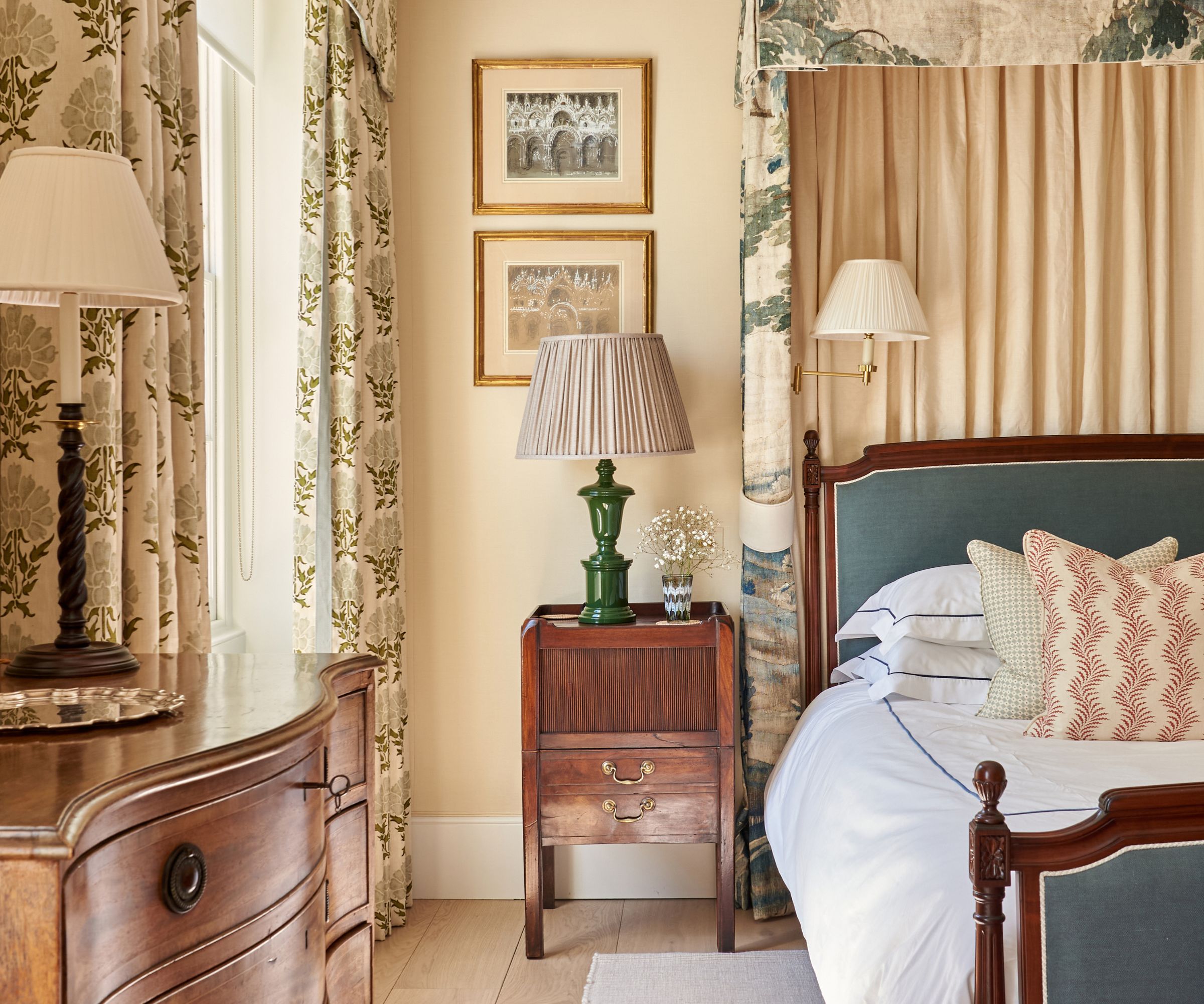 Chambre vintage avec rideaux imprimés, table d'appoint en bois, lampes vintage et lit en bois