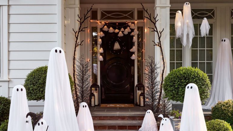 Porch decorated for Halloween with floating ghost decorations