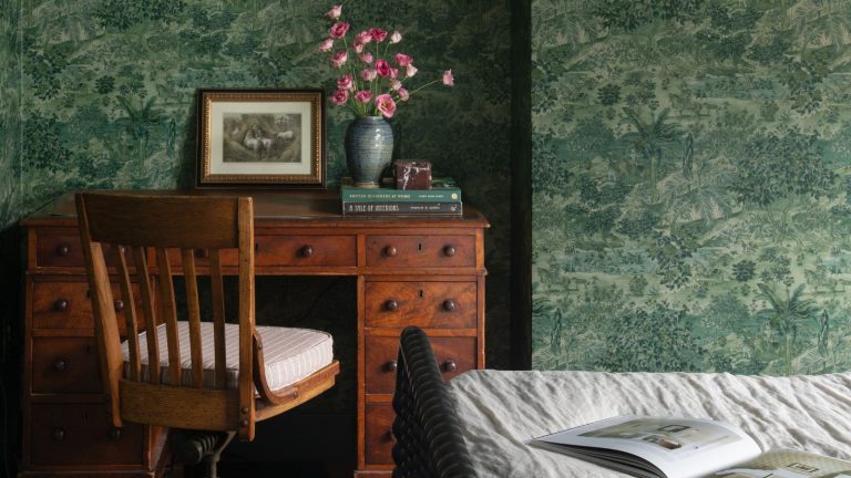 J’ai trouvé la lampe de style vintage parfaite à Walmart pour donner à ma chambre le look confortable et en couches qui manquait – et il a l’air bien plus cher que 40 $ vintage style bedroom with green leafy wallpaper, a wrought iron bed and a large antique wooden desk and chair