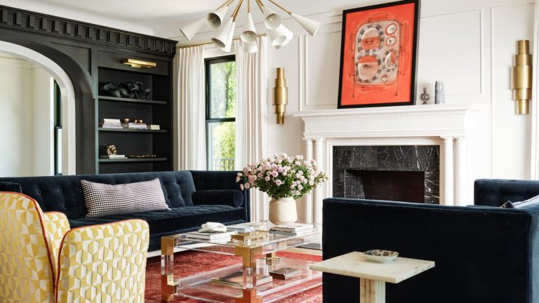 « Assez audacieux pour les espaces contemporains, mais assez intemporels pour honorer le passé » – pourquoi Tricorn Black de Sherwin-Williams est un favori des créateurs aimés pour sa sophistication durable Living room with marble fireplace, pink rug, glass coffee table, black bookcase and abstract art