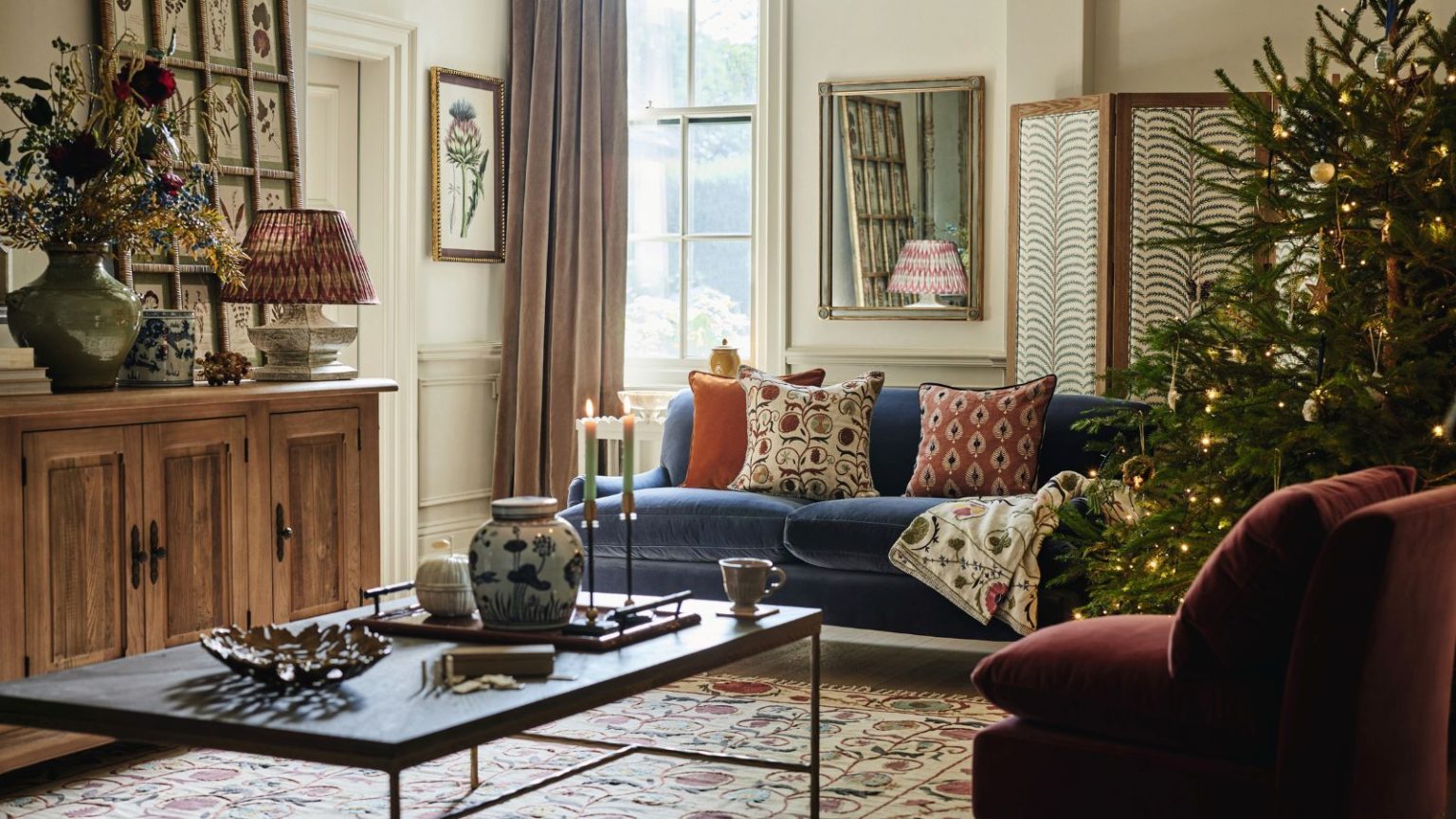 J’ai saupoudré cet ingrédient de cuisine sur le tapis sous mon sapin de Noël – les professionnels du nettoyage disent que cela change la donne pour un nettoyage rapide A cozy living room decorated for Christmas, with a large real tree in the right hand corner.