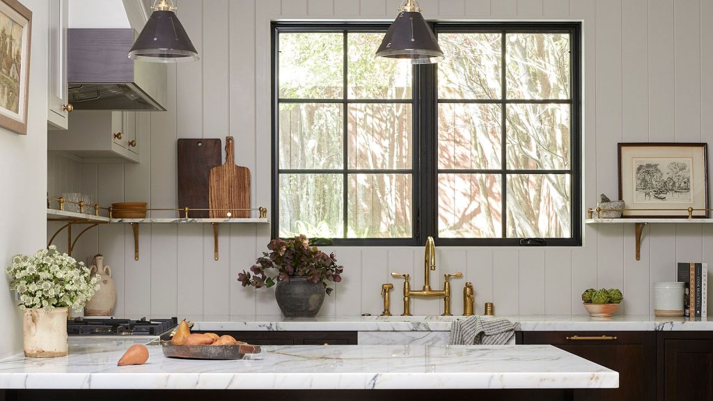 White kitchen with marble top and dark cabinets