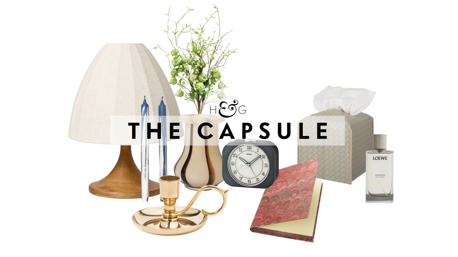 La décoration de chevet : 18 touches inspirées de l’hôtel qui rendront instantanément votre table de chevet plus élégante Bedside table decor pictured against a white background, including a table lamp, taper candle duo, brass candlestick, striped vase, retro-style alarm clock, patterned notebook, woven leather tissue cover, and Loewe Home spray