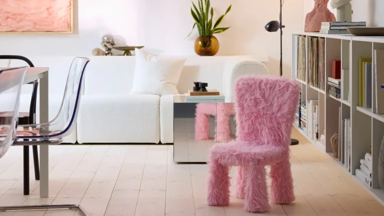A pink fluffy chair in a neutral living room