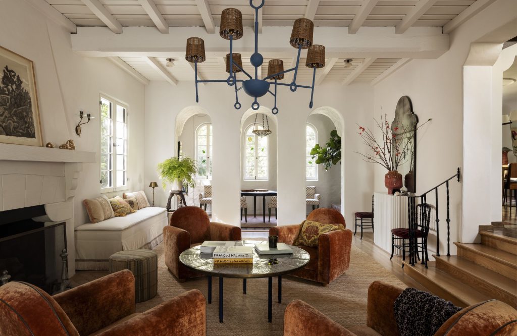 A living room in California's Los Feliz neighborwood, complete with arched openings on one end and a cluster of club chairs in the center.