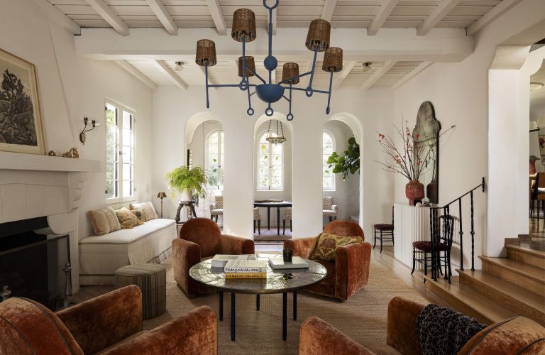 A living room in California's Los Feliz neighborwood, complete with arched openings on one end and a cluster of club chairs in the center.