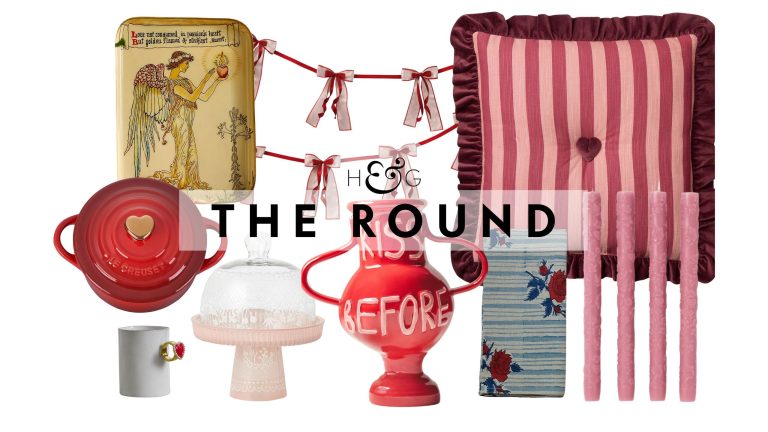 A collage of Valentine's Day Decor, including a heart-shapped Le Creuset, heart-ring mug, archival-style angel tray, cake cloche, red ceramic vase, bow garland, floral napkin, pink taper candles, and a striped throw pillow, pictured against a white background