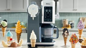 A Ninja&reg; CREAMi&reg; Scoop &amp; Swirl on a kitchen counter surrounded by swirled ice cream in cones.