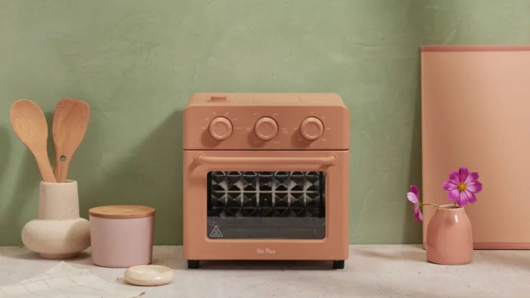 One of the best air fryer deals, Our Place Wonder Oven is discounted for Black Friday, pictured here in clay color with wooden cooking utensils