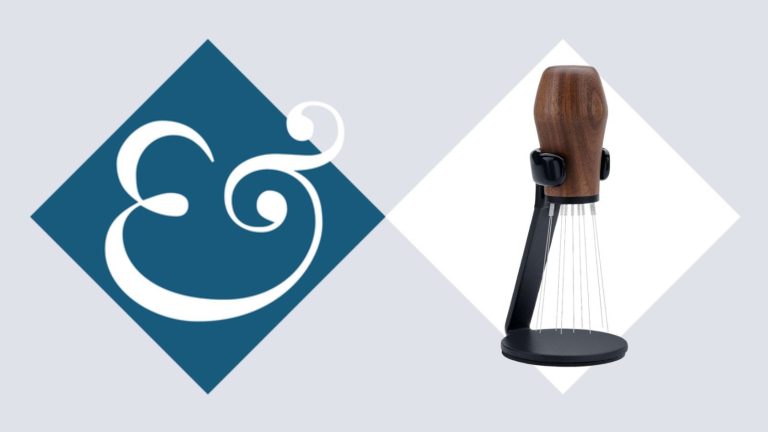 A wooden handled WDT needle tool on a Homes &amp; Gardens blue diamond background.