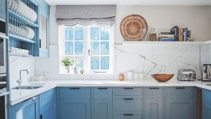 Duck egg blue kitchen with white marble counter and splashback