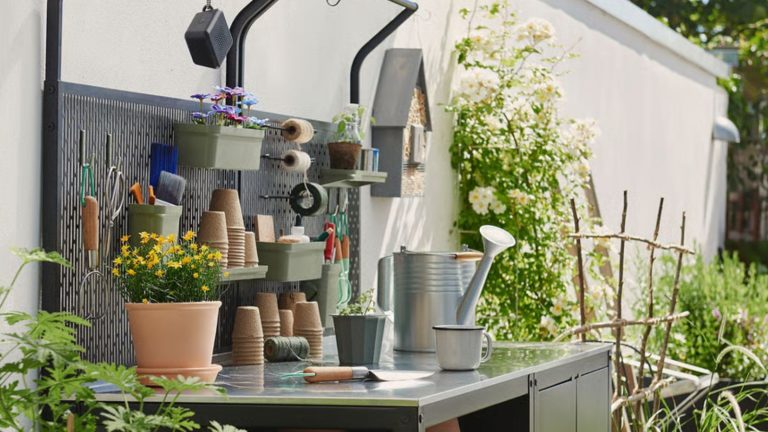 Stainless steel outdoor kitchen with pots and gardening tools