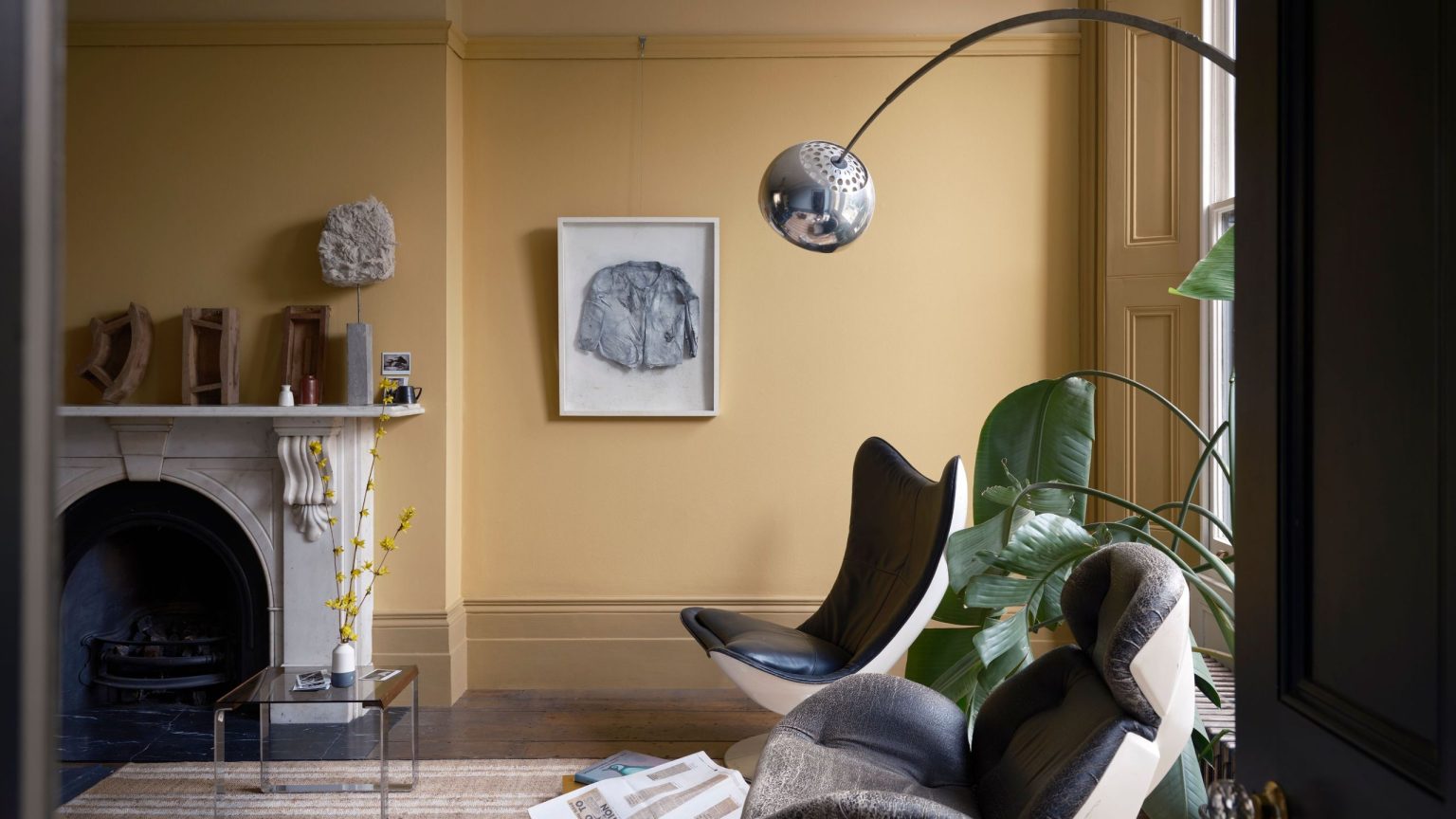 Pale yellow living room styled with mid-century style furniture