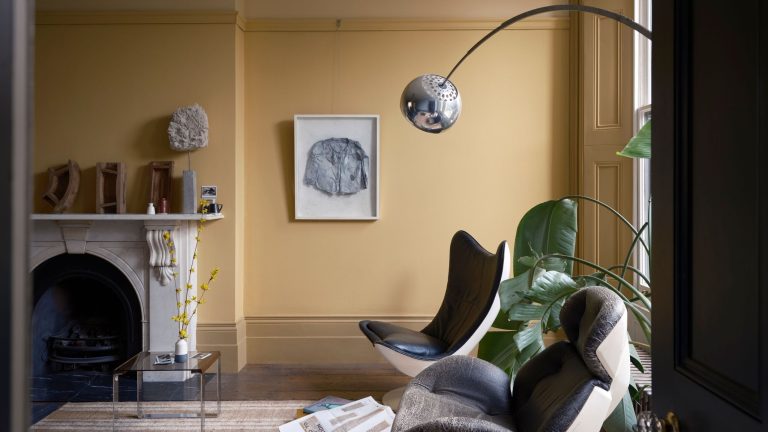 Pale yellow living room styled with mid-century style furniture
