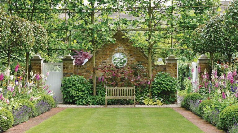 Garden borders with foxgloves, central lawn and a bench at the back