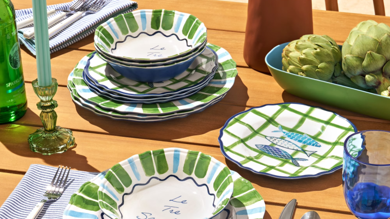 a green, white, and blue dinnerware set with sardine motifs on it