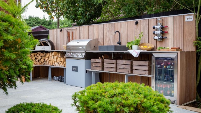 An outdoor kitchen with a countertop sink