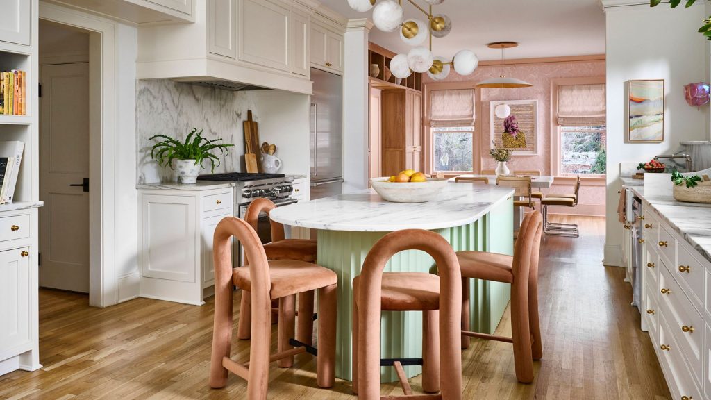 Cheerful eat-in kitchen area featuring a mint green island surrounded by contemporary peach dining chairs