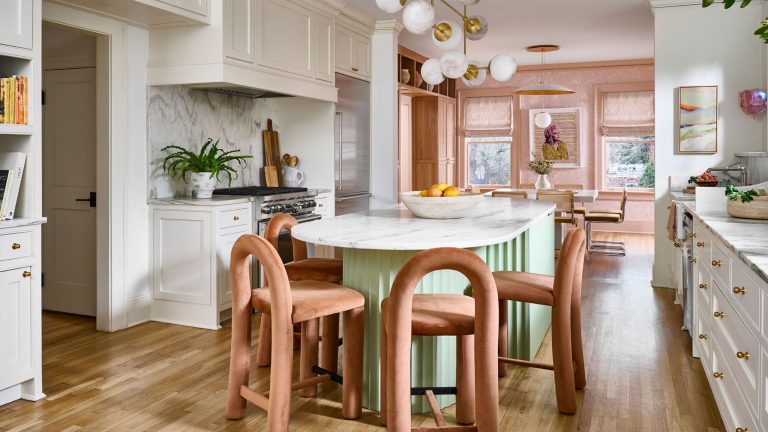 Cheerful eat-in kitchen area featuring a mint green island surrounded by contemporary peach dining chairs