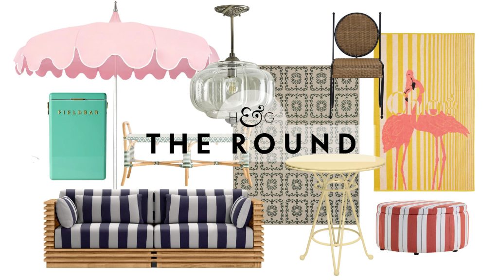South-of-France-inspired outdoor decor, including a patio umbrella, Kelly green Fieldbar cooler, striped teak wood sofa, Eloise outdoor pendant light, patterned rug, yellow bistro table, and more