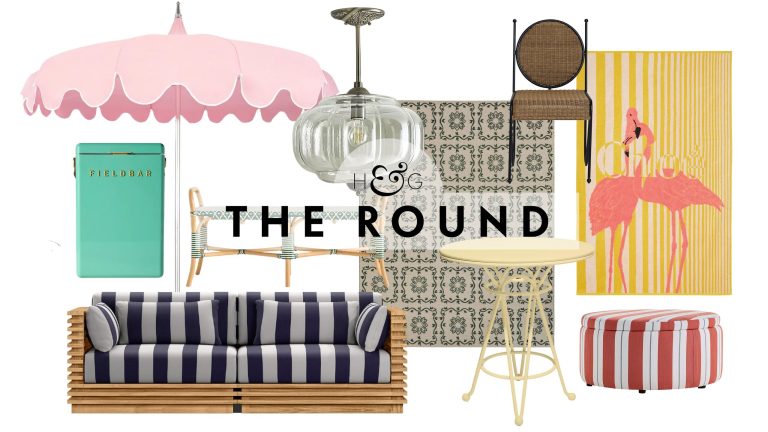 South-of-France-inspired outdoor decor, including a patio umbrella, Kelly green Fieldbar cooler, striped teak wood sofa, Eloise outdoor pendant light, patterned rug, yellow bistro table, and more